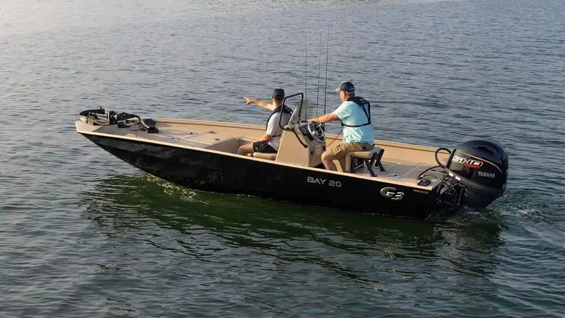 Slide: The Image of G3 Bay 20 boat 2026 on calm water with two people. - 25