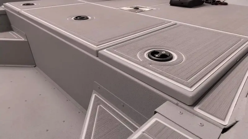 Slide: The Image of G3 Bay 17 boat 2026, gray deck surface with storage compartments. - 18