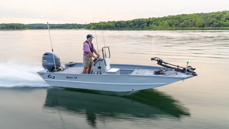 Slide: The Image of G3 Bay 17 boat 2026 cruising on a calm lake at sunset. - 23