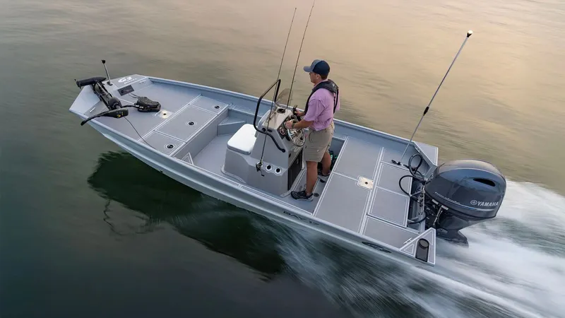 Slide: The Image of Man driving 2026 G3 Bay 17 boat on calm water. - 24
