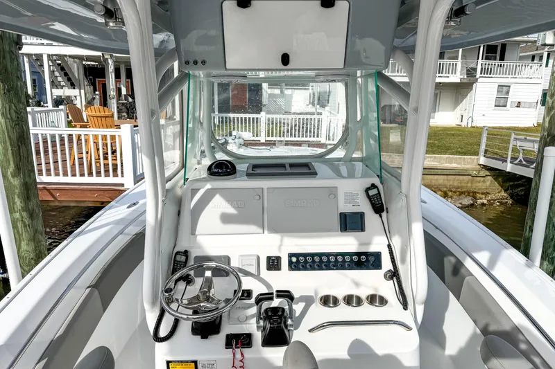 Slide: The Image of 2021 Cape Horn 31 T boat with Yamaha 300 engines, featuring a cushioned bench and storage compartments. - 26