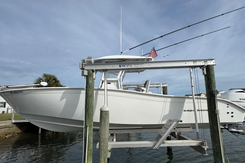 The Image of 2021 Cape Horn 31 T boat on lift, docked with fishing rods and American flag. - 0