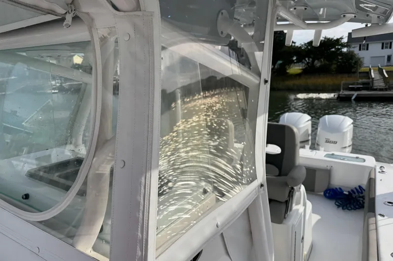 Slide: The Image of 2021 Cape Horn 31 T boat with dual engines, docked near waterfront homes. - 19