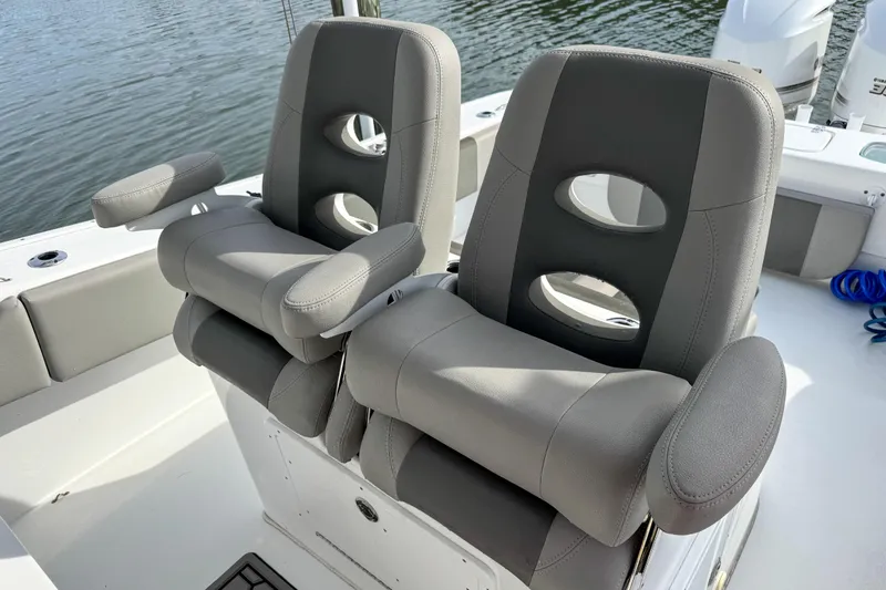 Slide: The Image of 2021 Cape Horn 31 T boat interior with seating and speakers, docked by a wooden railing. - 22