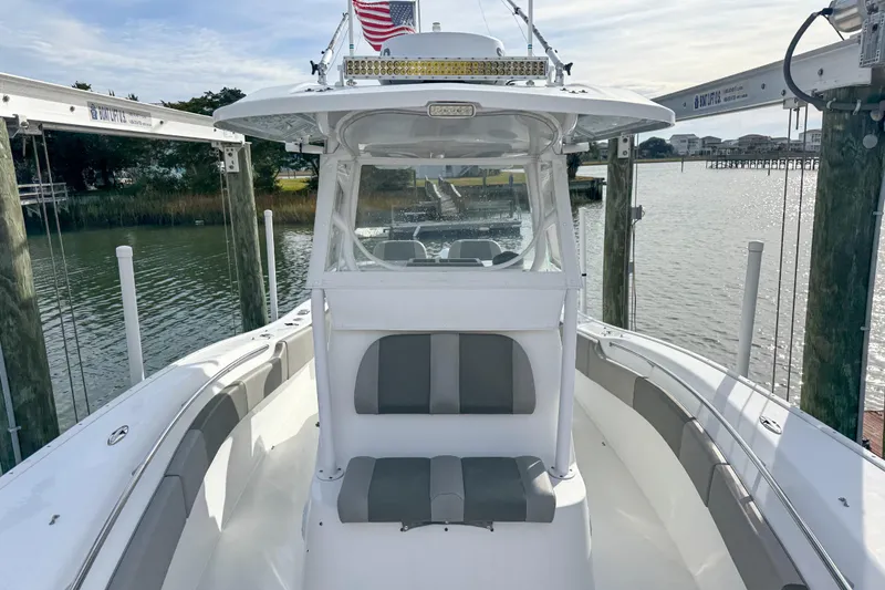 Slide: The Image of Twin Yamaha 300 engines on a 2021 Cape Horn 31 T boat, docked on water. - 27