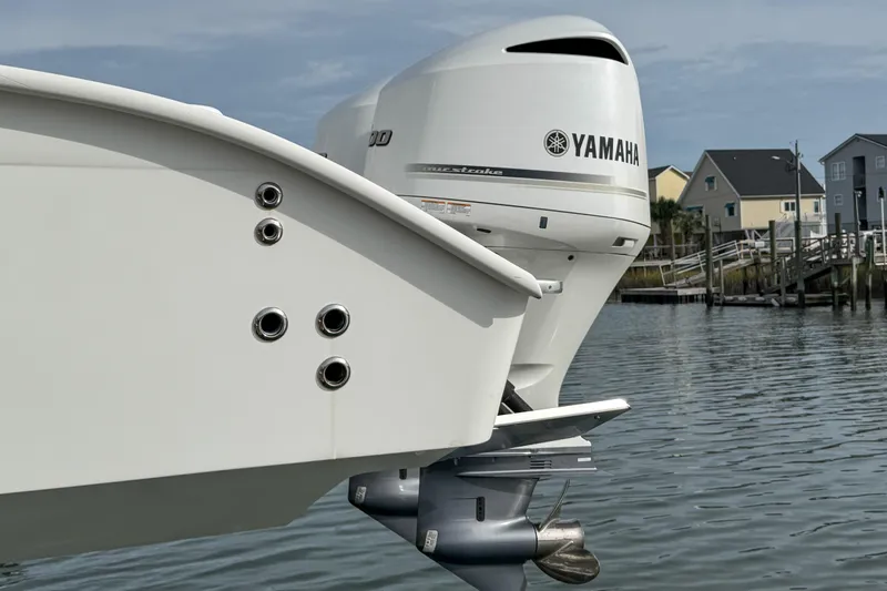 Slide: The Image of 2021 Cape Horn 31 T boat docked with fishing rods and American flag. - 4