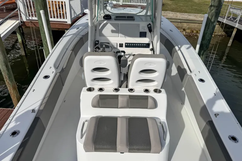 Slide: The Image of 2021 Cape Horn 31 T boat interior with seating and console, docked by the water. - 8