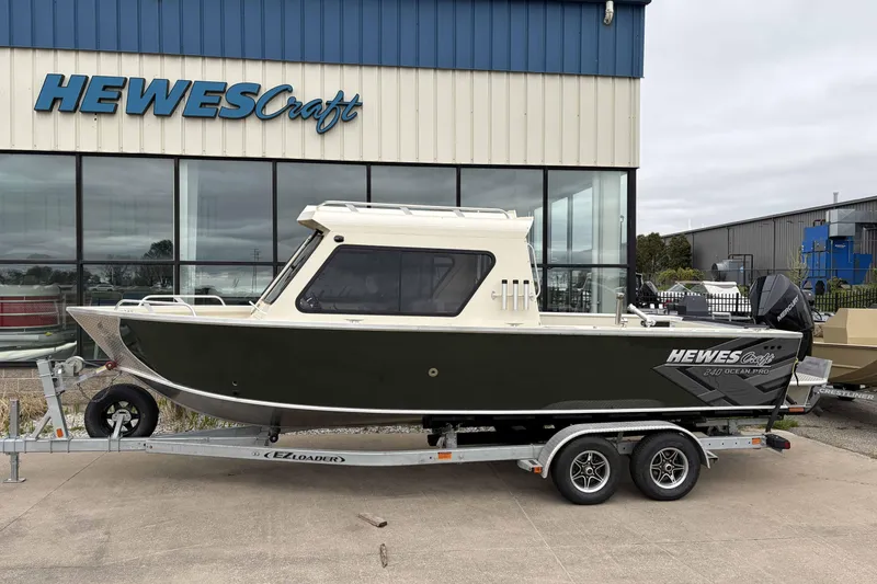 The Image of 2026 Hewescraft 240 Ocean Pro ET Hardtop boat on trailer outside showroom. - 0