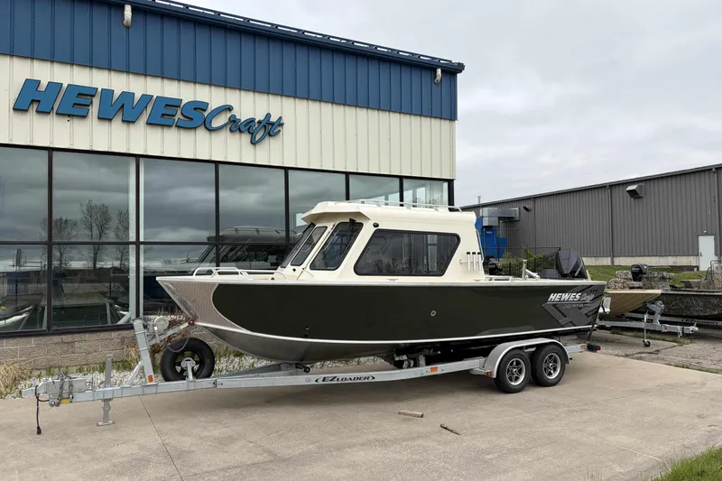 Slide: The Image of 2026 Hewescraft 240 Ocean Pro ET Hardtop boat on trailer outside showroom. - 1