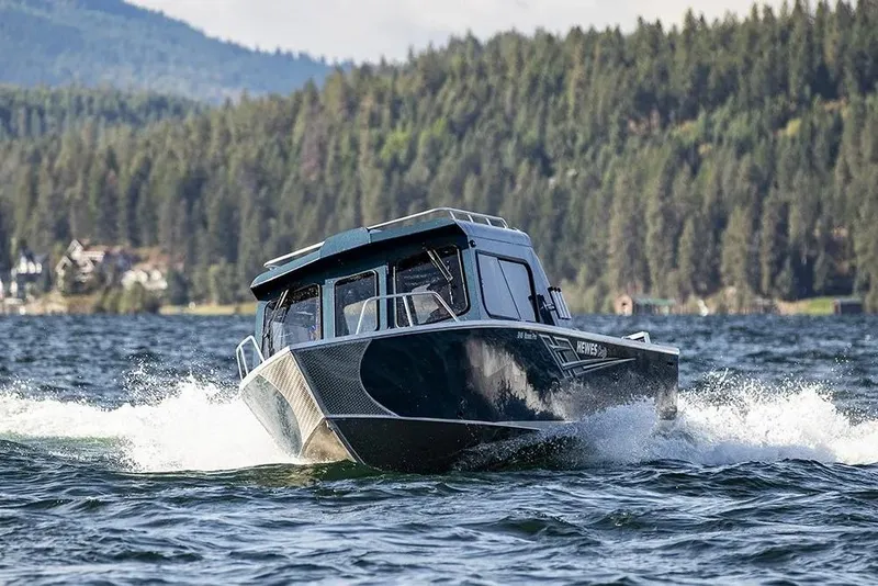 Slide: The Image of 2026 Hewescraft 240 Ocean Pro ET HT cruising on a scenic lake. - 12