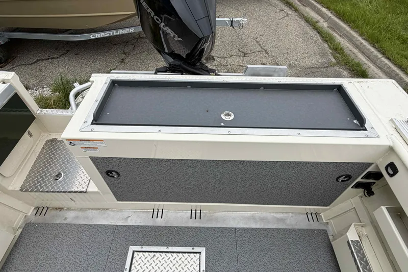 Slide: The Image of 2026 Hewescraft 240 Ocean Pro ET Hardtop boat interior with storage compartment and Mercury engine. - 8