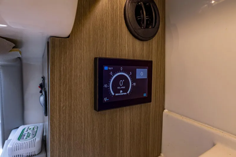 Slide: The Image of Control panel in 2022 Regal LX36 boat interior, displaying roll angle and voltage. - 19