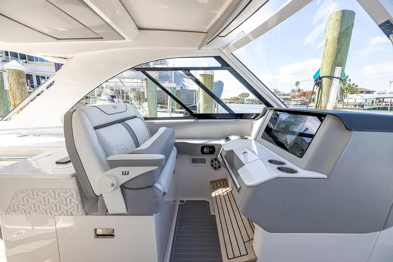 Slide: The Image of 2022 Regal LX36 boat interior with modern helm, luxurious seating, and advanced navigation system. - 26