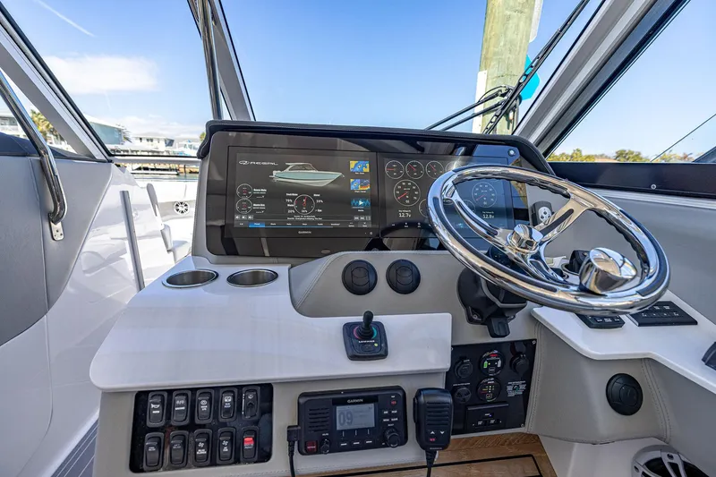 Slide: The Image of 2022 Regal LX36 boat helm with advanced navigation display and controls. - 29