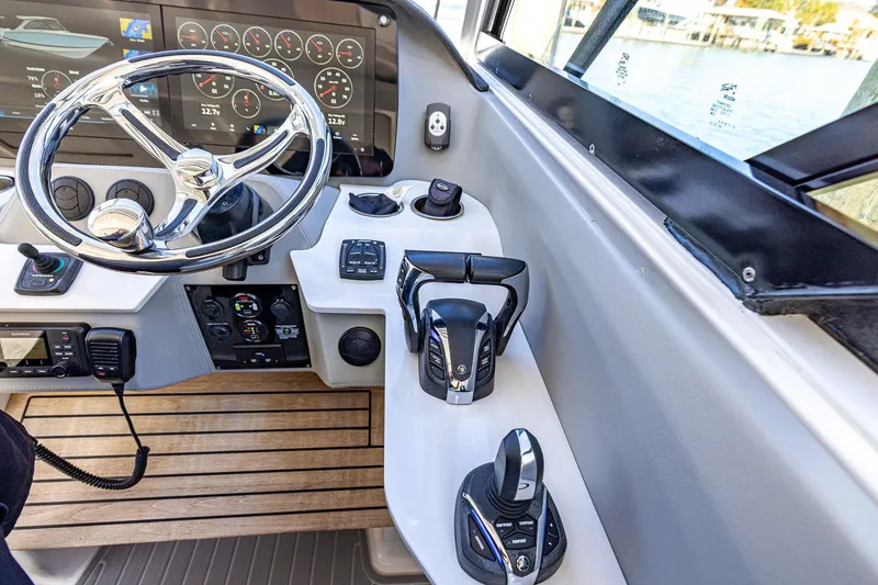 Slide: The Image of 2022 Regal LX36 boat helm with modern controls and digital displays. - 33