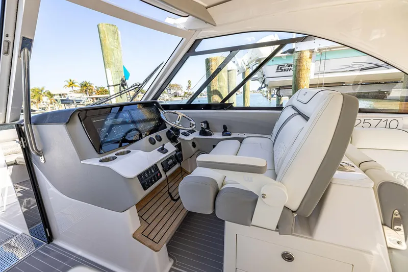 Slide: The Image of 2022 Regal LX36 boat cockpit with modern controls and luxurious seating. - 34