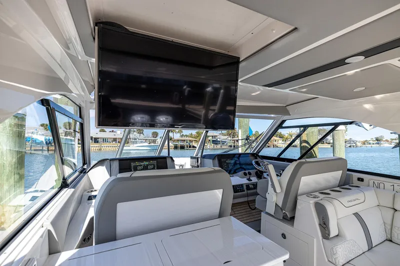 Slide: The Image of Interior of 2022 Regal LX36 yacht with modern helm, seating, and large TV screen. - 35
