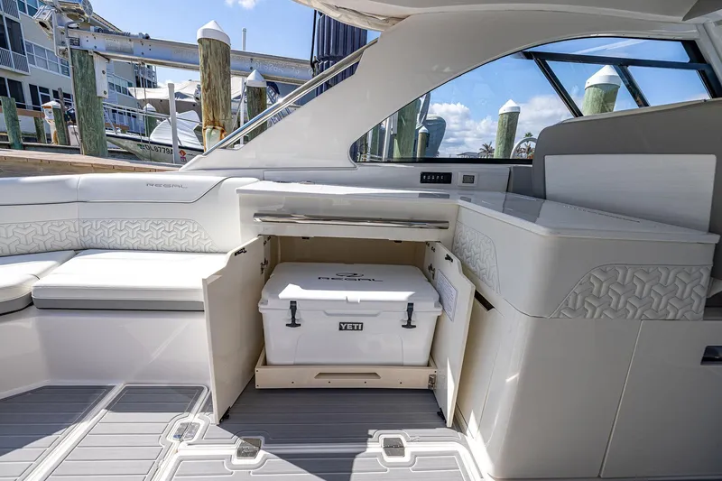 Slide: The Image of 2022 Regal LX36 boat interior with Yeti cooler, luxurious seating, and modern design. - 38