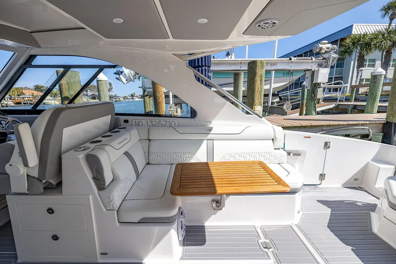 Slide: The Image of Luxurious 2022 Regal LX36 yacht interior with elegant seating and wooden table at marina. - 42
