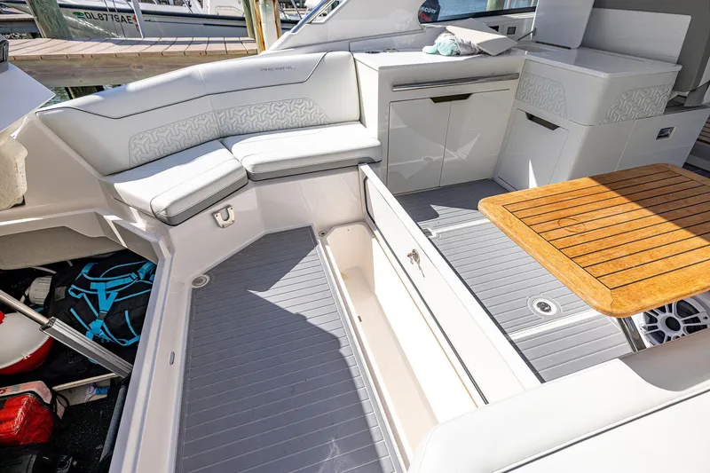 Slide: The Image of Luxurious 2022 Regal LX36 boat interior with seating and wooden table. - 47