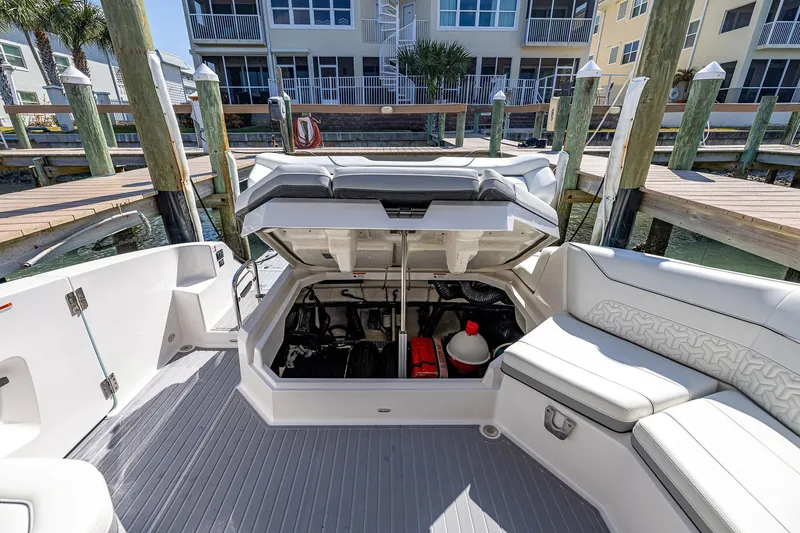 Slide: The Image of 2022 Regal LX36 boat interior with open storage compartment at dockside. - 48