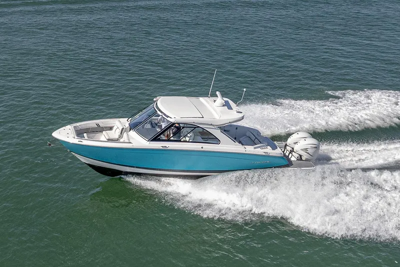 Slide: The Image of 2022 Regal LX36 boat cruising on open water, showcasing sleek design and powerful engines. - 5
