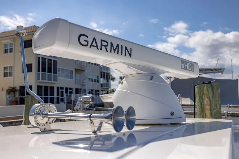 Slide: The Image of 2022 Regal LX36 boat with Garmin xHD2 radar, docked near waterfront buildings. - 61