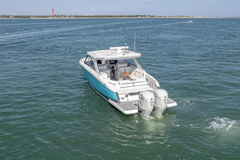 Slide: The Image of 2022 Regal LX36 boat cruising on open water with twin engines. - 67