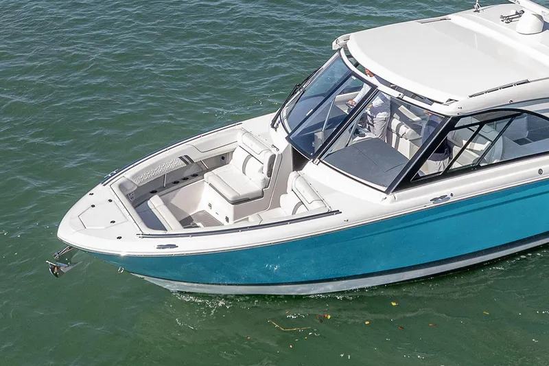 Slide: The Image of 2022 Regal LX36 boat with sleek design on calm water. - 7