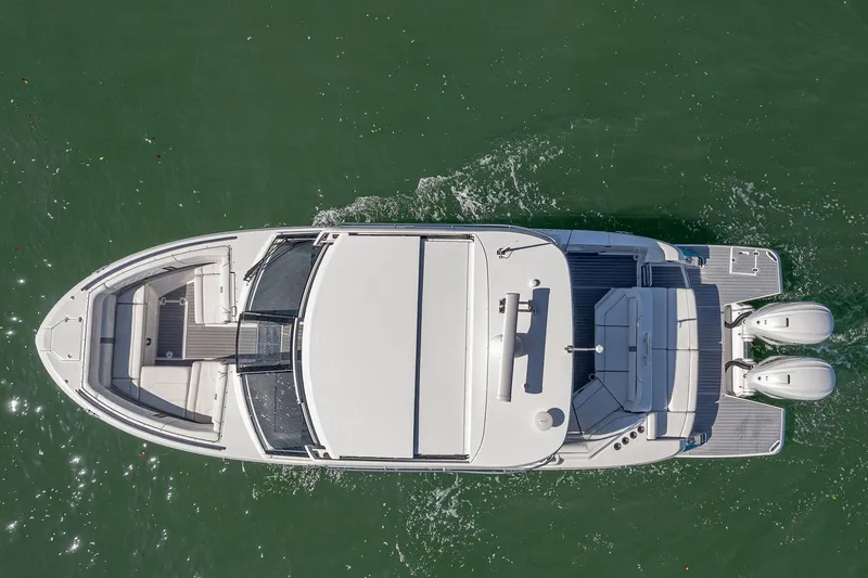Slide: The Image of Overhead view of 2022 Regal LX36 boat cruising on water. - 72