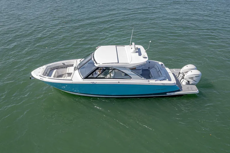 Slide: The Image of 2022 Regal LX36 boat on water, featuring sleek design and dual outboard engines. - 77