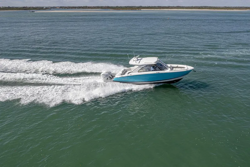 Slide: The Image of 2022 Regal LX36 boat cruising on open water, creating a dynamic wake. - 81