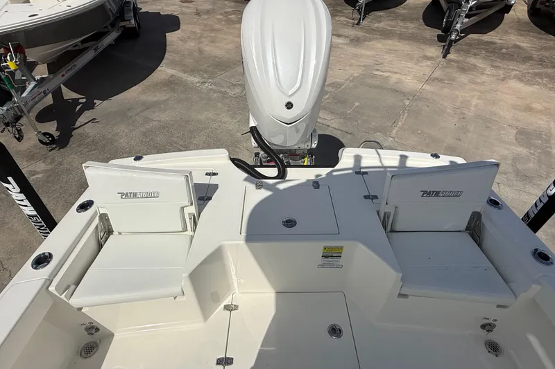 Slide: The Image of 2026 Pathfinder 2500 Hybrid boat deck with seating and motor, displayed outdoors. - 11