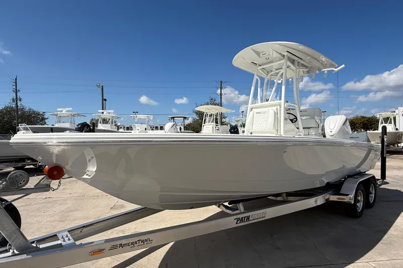Slide: The Image of 2026 Pathfinder 2500 Hybrid boat on trailer under clear blue sky. - 13