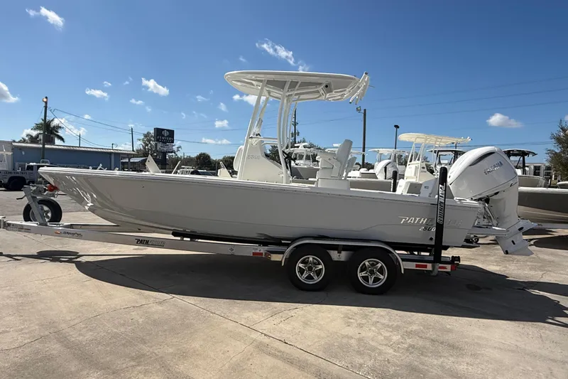 Slide: The Image of 2026 Pathfinder 2500 Hybrid boat on trailer under clear blue sky. - 14