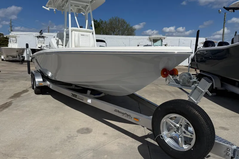 Slide: The Image of 2026 Pathfinder 2500 Hybrid boat on trailer under clear blue sky. - 2