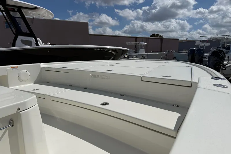 Slide: The Image of 2026 Pathfinder 2500 Hybrid boat, sleek design, docked under a partly cloudy sky. - 4