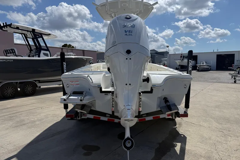 Slide: The Image of 2026 Pathfinder 2500 Hybrid boat with powerful V6 engine, parked outdoors under a cloudy sky. - 8