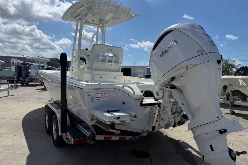 Slide: The Image of 2026 Pathfinder 2500 Hybrid boat with Yamaha engine on trailer under blue sky. - 9