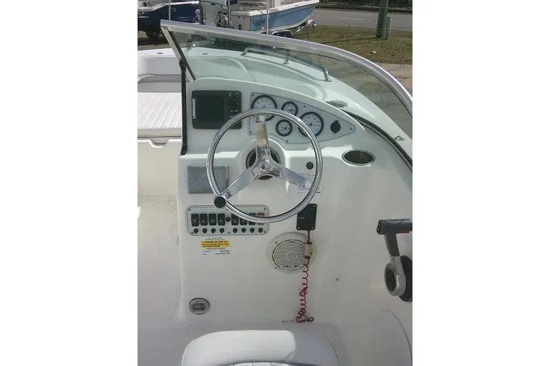 Slide: The Image of 2011 Tidewater 196 DC Explorer boat dashboard with steering wheel and control panel. - 12