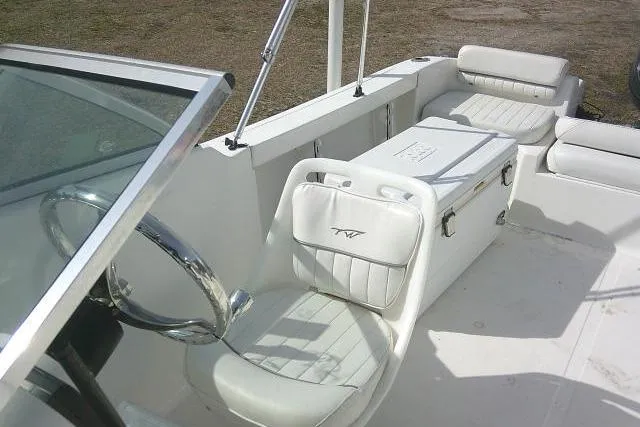 Slide: The Image of 2011 Tidewater 196 DC Explorer boat interior with white seating and steering wheel. - 17
