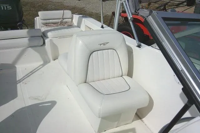 Slide: The Image of 2011 Tidewater 196 DC Explorer boat interior with white seating and console. - 18