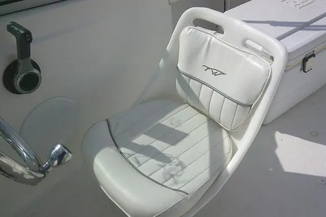Slide: The Image of White seat on 2011 Tidewater 196 DC Explorer boat, featuring logo and control lever. - 19