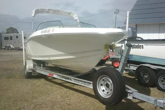 Slide: The Image of 2011 Tidewater 196 DC Explorer boat on trailer, parked outdoors. - 2