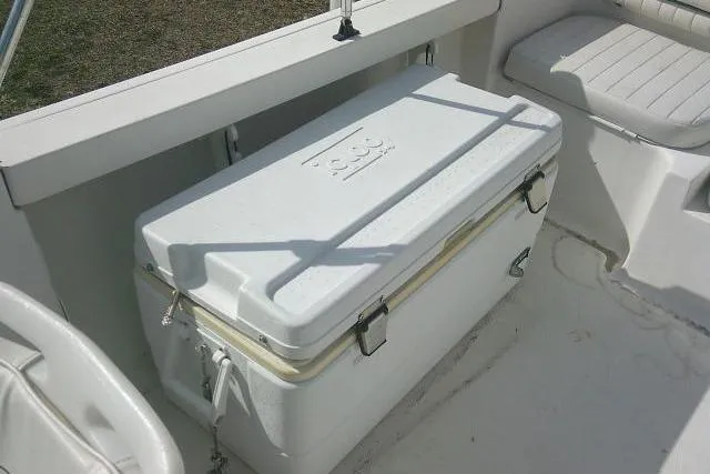 Slide: The Image of White cooler on 2011 Tidewater 196 DC Explorer boat deck, secured with straps. - 23