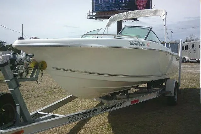 Slide: The Image of 2011 Tidewater 196 DC Explorer boat on trailer, parked outdoors. - 4