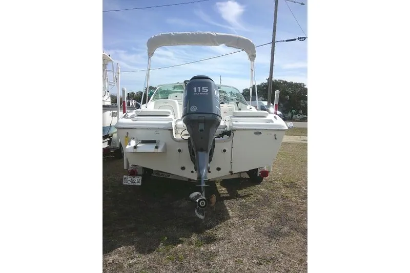 Slide: The Image of 2011 Tidewater 196 DC Explorer boat with outboard motor, parked on grass. - 7