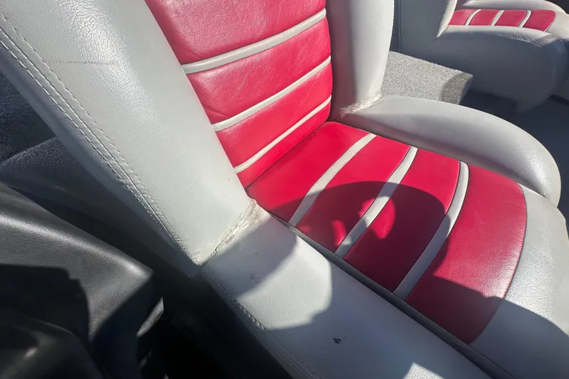 Slide: The Image of Red and gray boat seat in a 2009 Triton 21X3 Pro DC. - 14