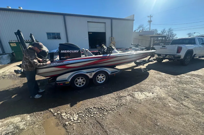 Slide: The Image of 2009 Triton 21X3 Pro DC boat on trailer, attached to a white GMC truck. - 15