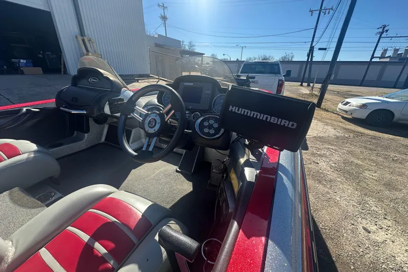 Slide: The Image of 2009 Triton 21X3 Pro DC boat interior with steering wheel and Humminbird fish finder. - 16